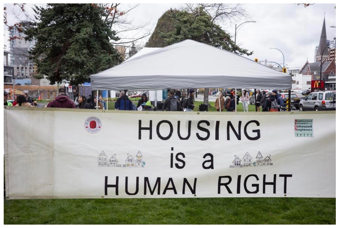 NSUN "housing is a human right" banner at an event held on Pandora Avenue