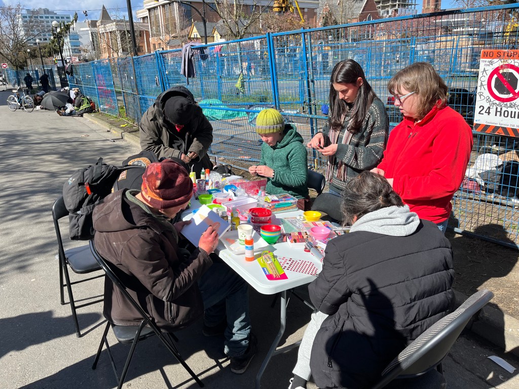 people doing art at a table