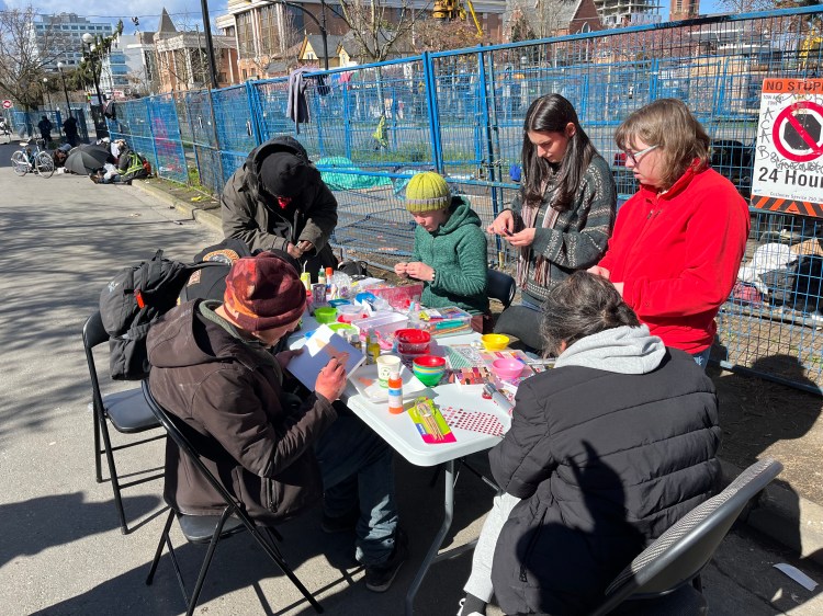 people doing art at a table